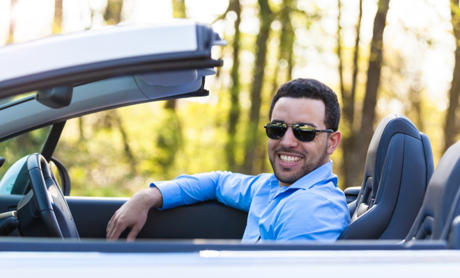 man driving in his convertable car