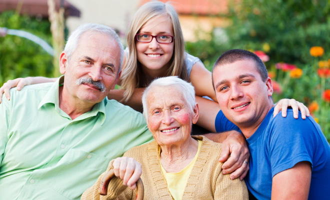 grandmother son and grandchildren sitting in garden